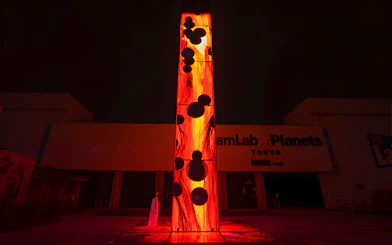 Entrance to teamLab Planets Tokyo with illuminated art installation.