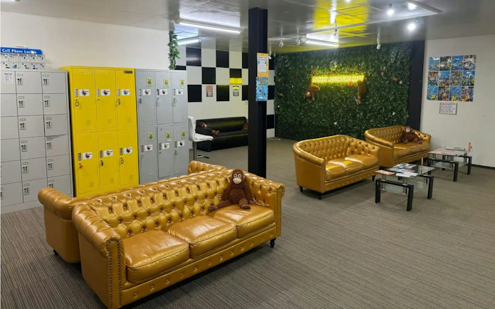 Go-karting lounge with yellow sofas, lockers, and Monkey Kart decor in Asakusa.