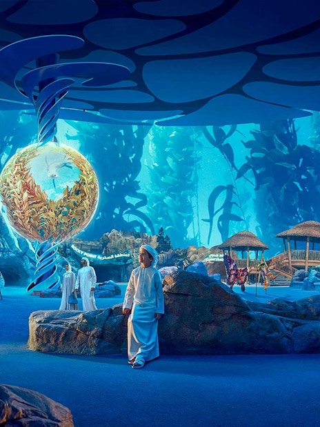 Visitors exploring underwater-themed exhibits at SeaWorld Abu Dhabi.