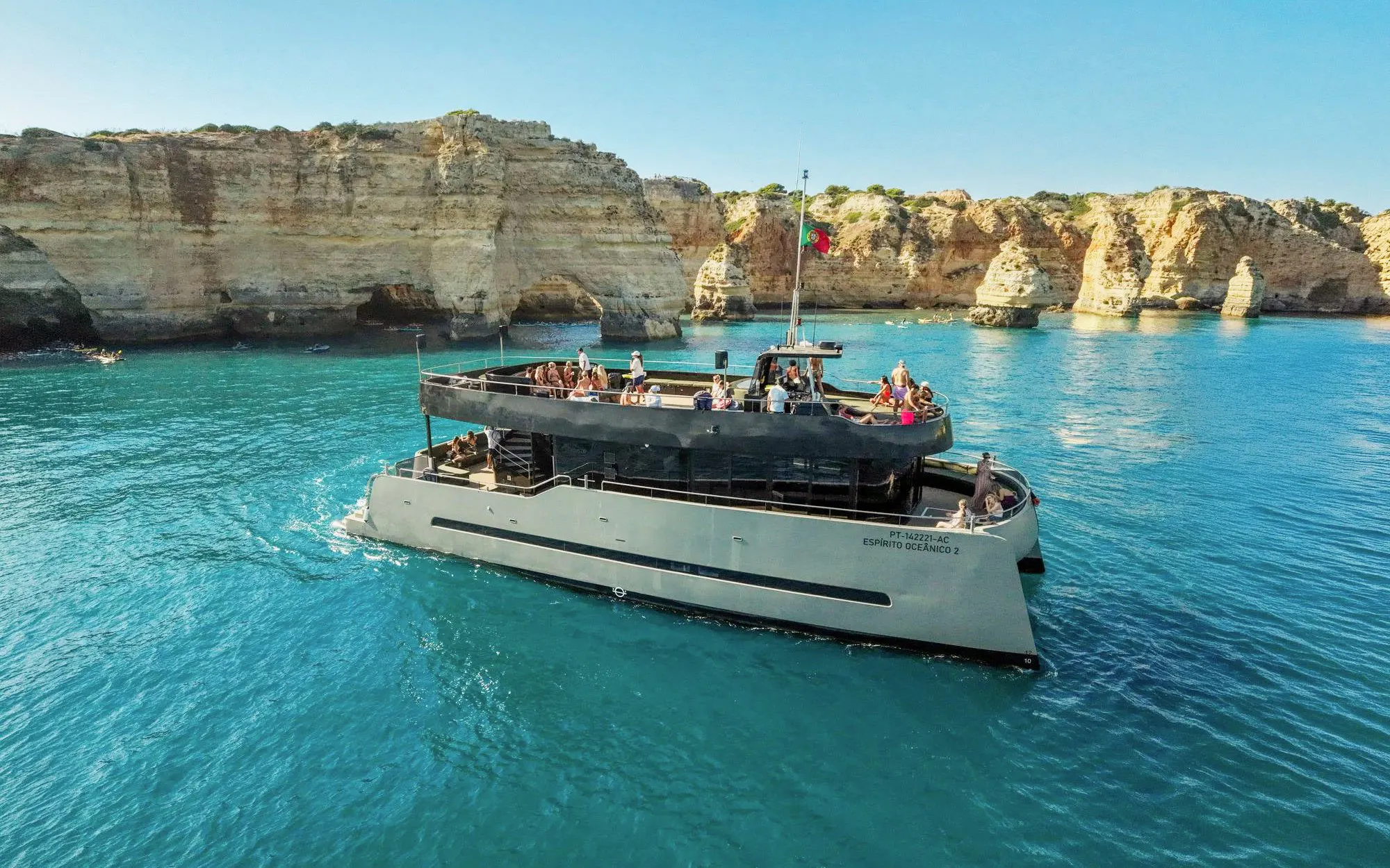 Boat tour near Benagil Caves, Vilamoura, with passengers enjoying the view.
