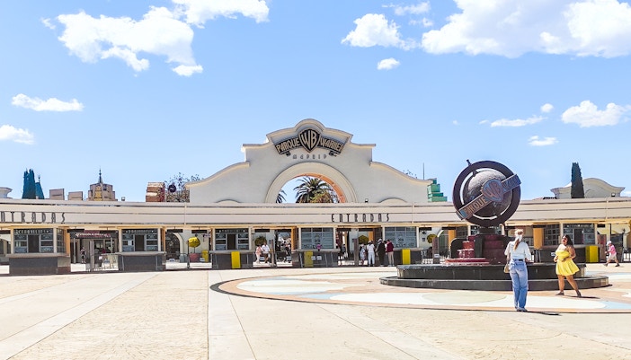 Parque Warner entrance with iconic cartoon character statues, Madrid, Spain.