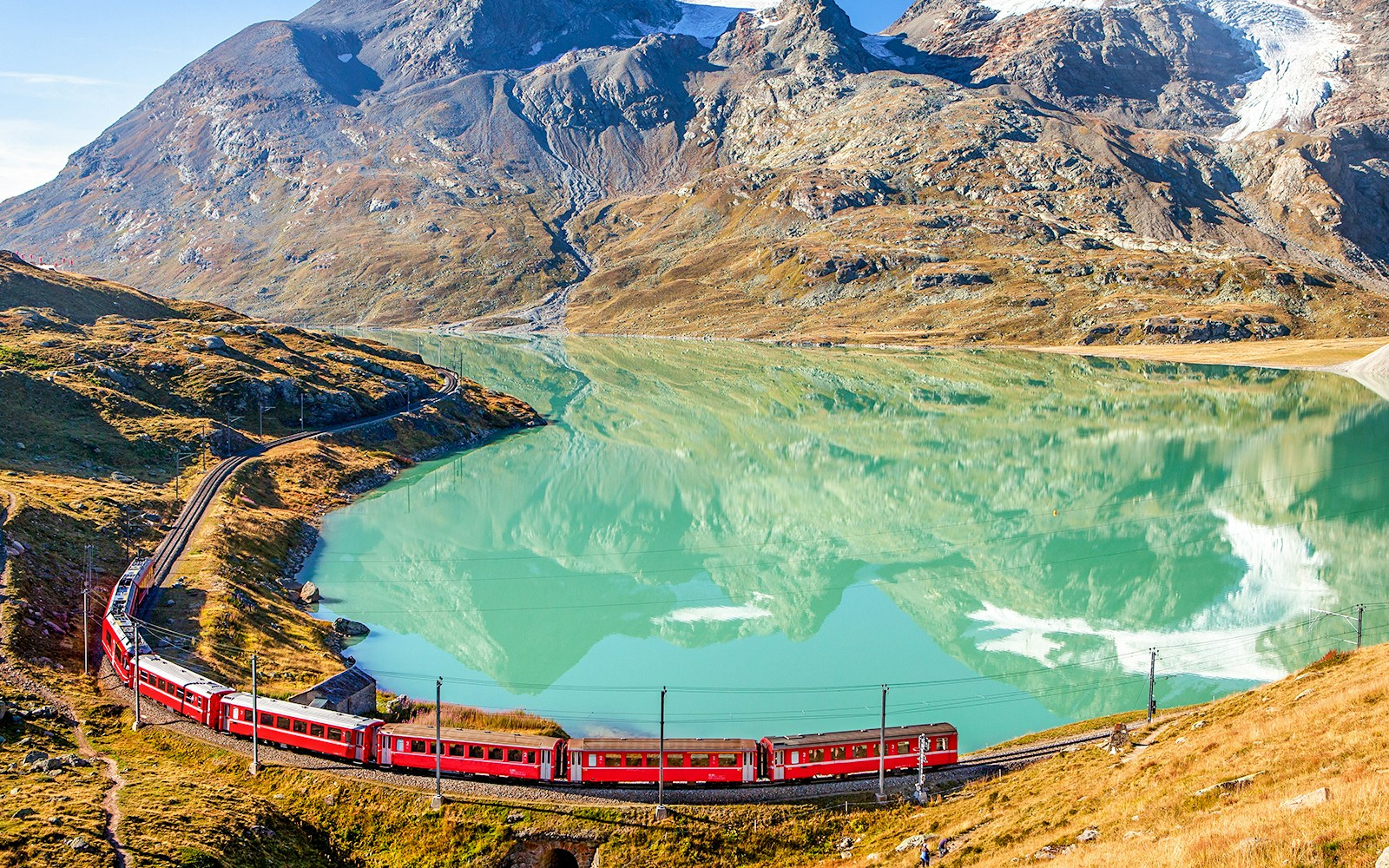 Lago Bianco aerial view with the Bernina Express in sight during summer.