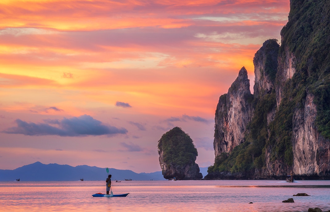 Phi Phi Islands sunset view with boats on the water, Thailand.