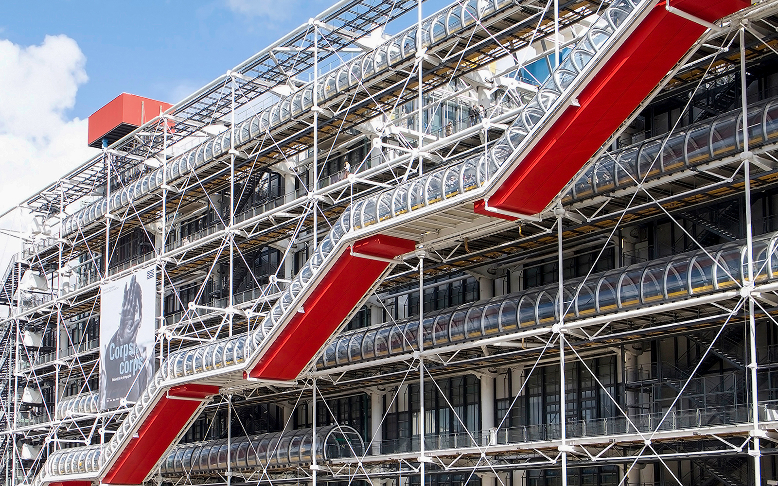 Centre Pompidou exterior with red escalators and exposed structural design in Paris.