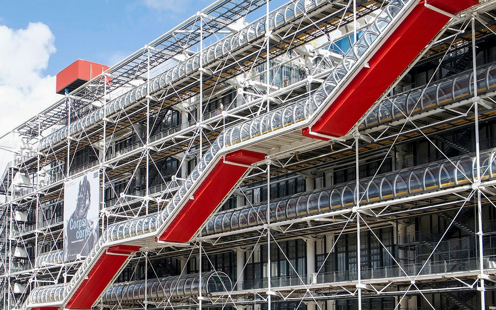 Centre Pompidou exterior with red escalators and exposed structural design in Paris.