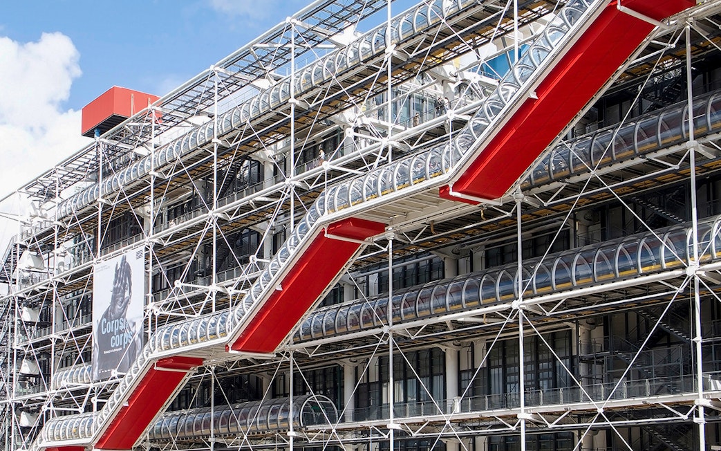 Centre Pompidou exterior with red escalators and exposed structural design in Paris.