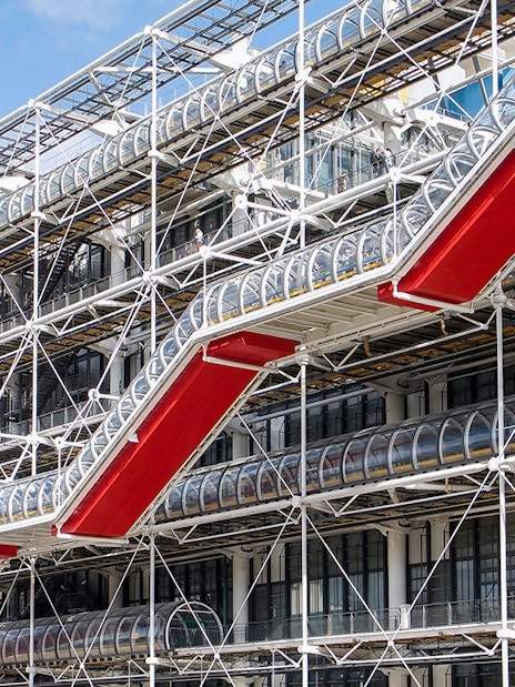 Centre Pompidou exterior with red escalators and exposed structural design in Paris.