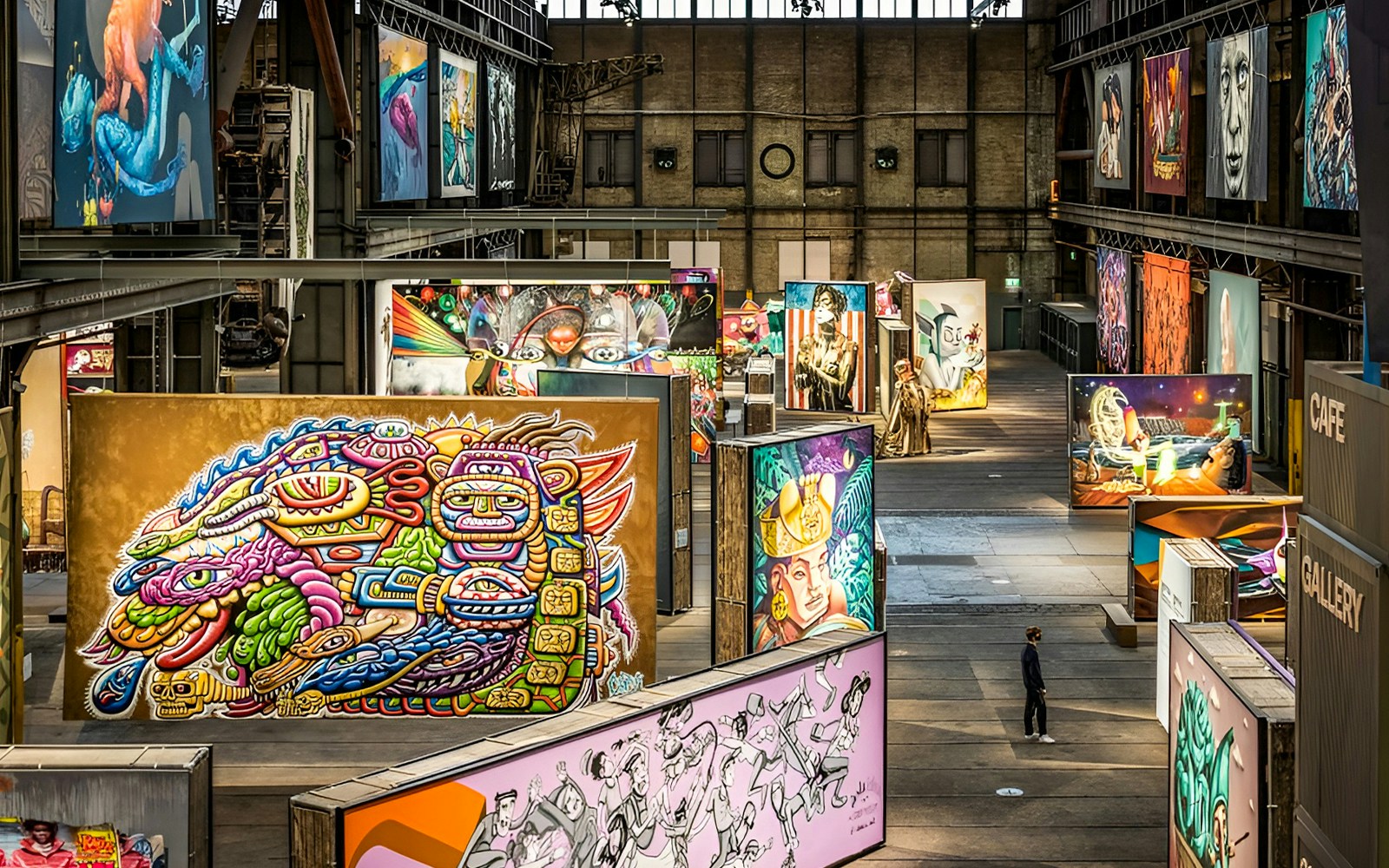 STRAAT Museum exterior with vibrant street art and Amsterdam canal cruise boat.