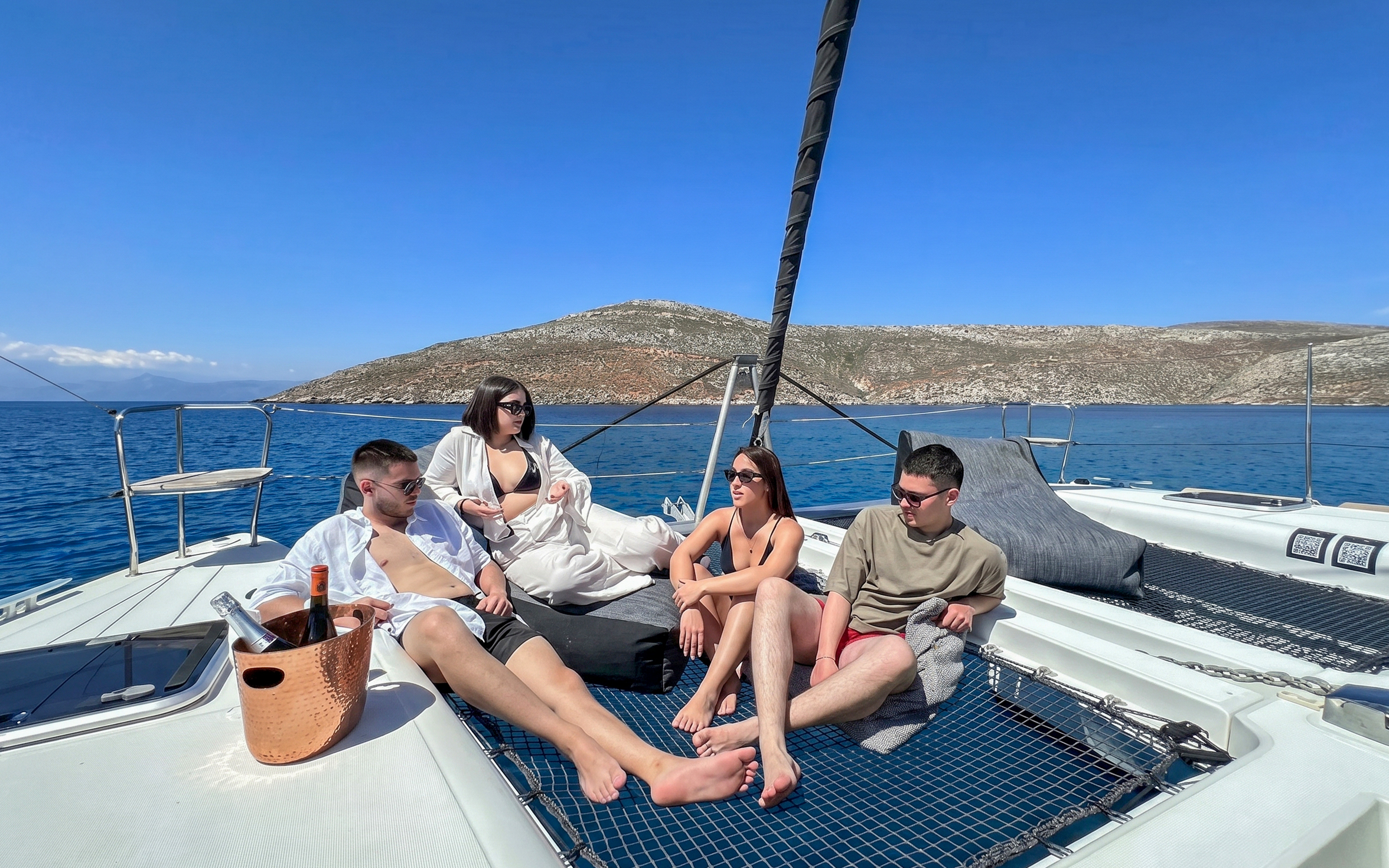 Catamaran cruise in Heraklion with guests relaxing on deck, enjoying the sea view.