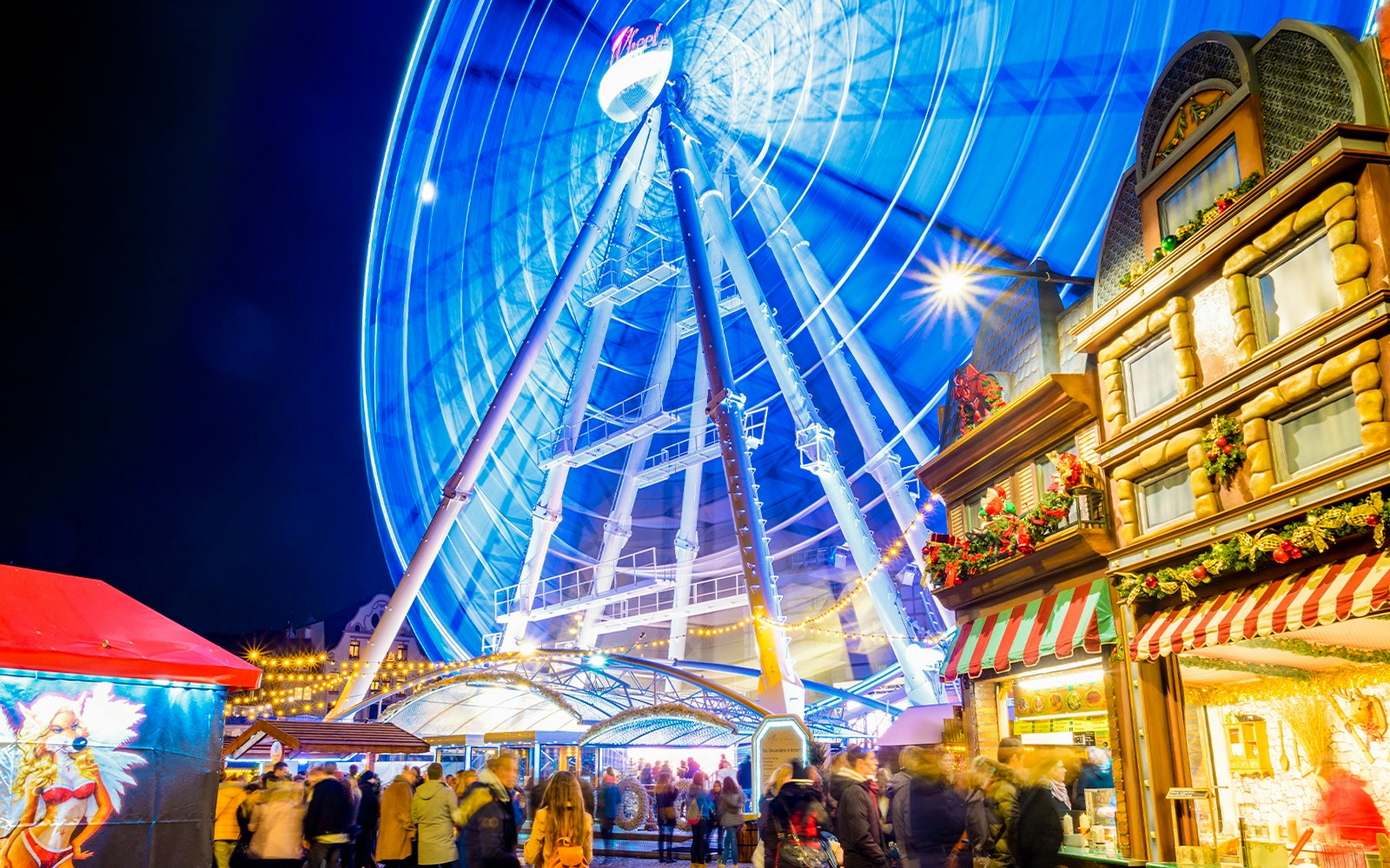 Tibidabo Christmas Fair with festive stalls and Ferris wheel in Barcelona.