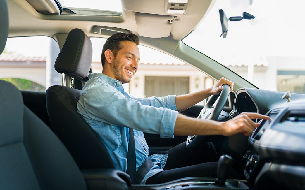 Driver using GPS navigation in car to reach Kuranda Village.