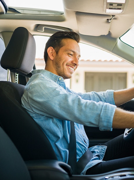 Driver using GPS navigation in car to reach Kuranda Village.