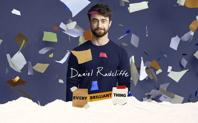 Actor surrounded by colorful paper pieces, promoting Every Brilliant Thing Broadway show.