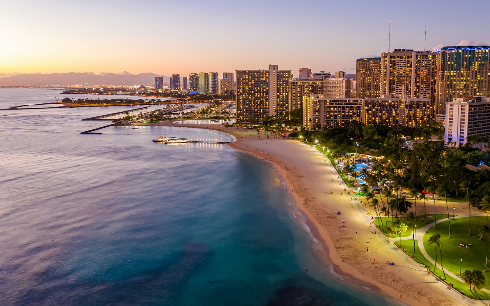 Aerial view of Waikiki Beach and Honolulu skyline at sunset, Oahu, Hawaii.