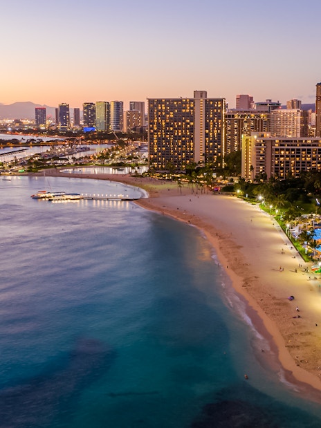 Aerial view of Waikiki Beach and Honolulu skyline at sunset, Oahu, Hawaii.