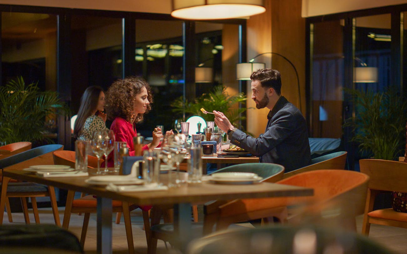 Couple dining on a Valentine's Day dinner cruise.
