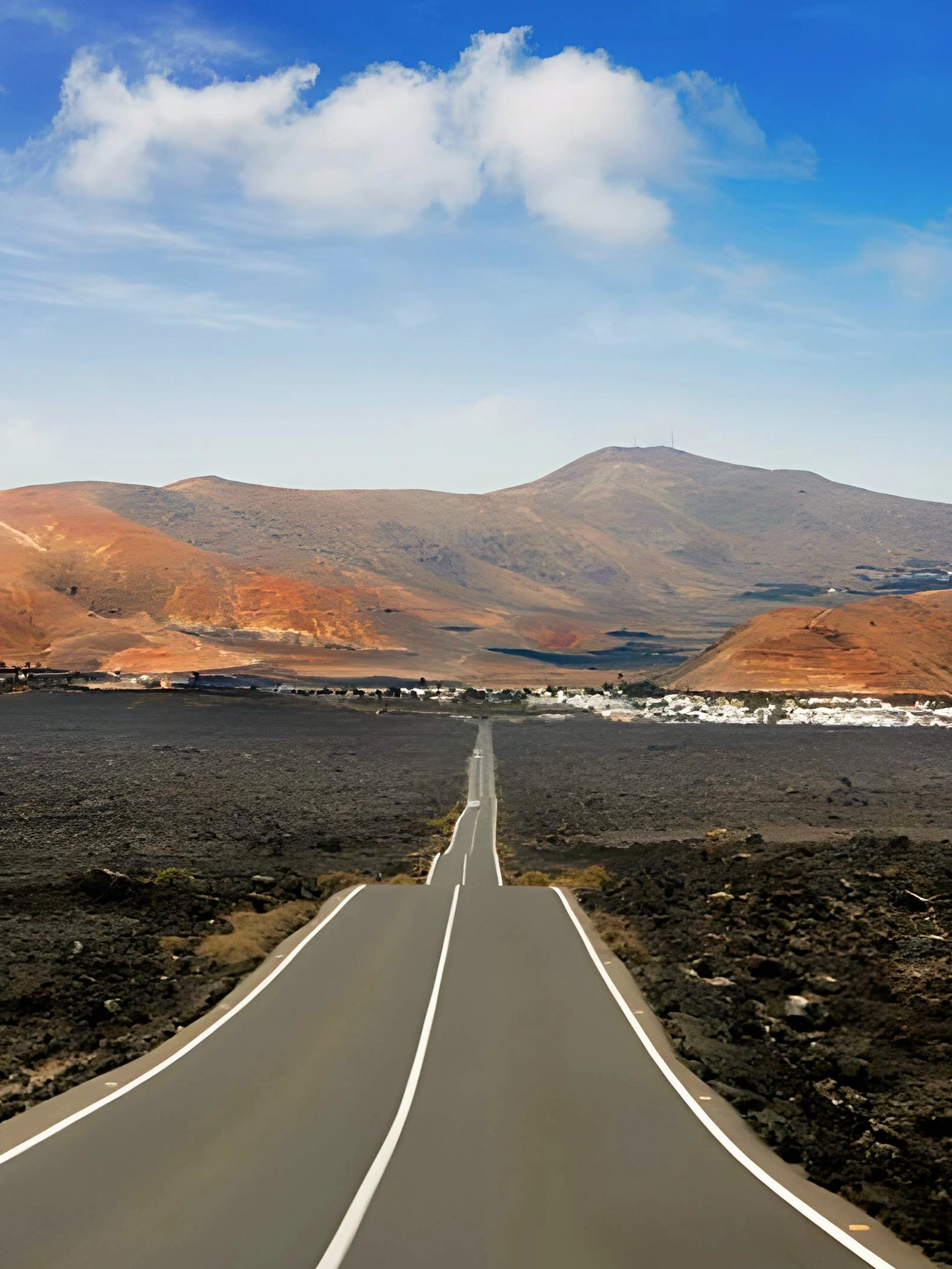 Road through volcanic landscape at Timanfaya National Park, Lanzarote.