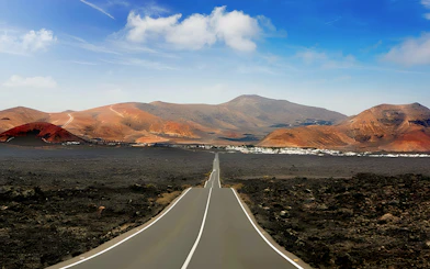 Road through volcanic landscape at Timanfaya National Park, Lanzarote.