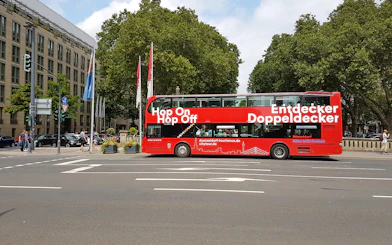 Red double-decker bus for hop on hop off city tour in Düsseldorf.