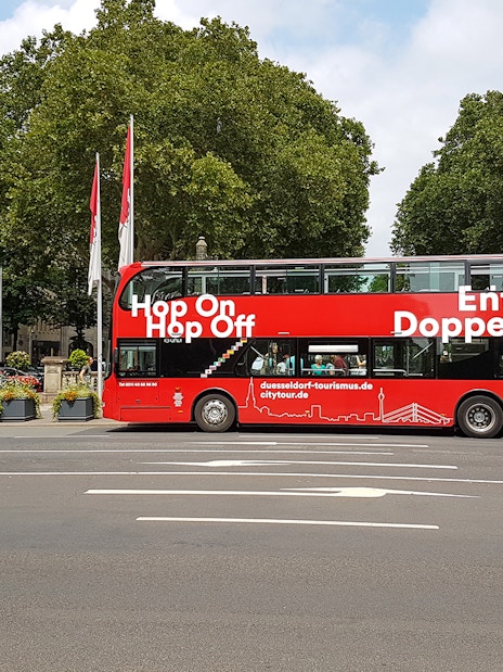 Red double-decker bus for hop on hop off city tour in Düsseldorf.