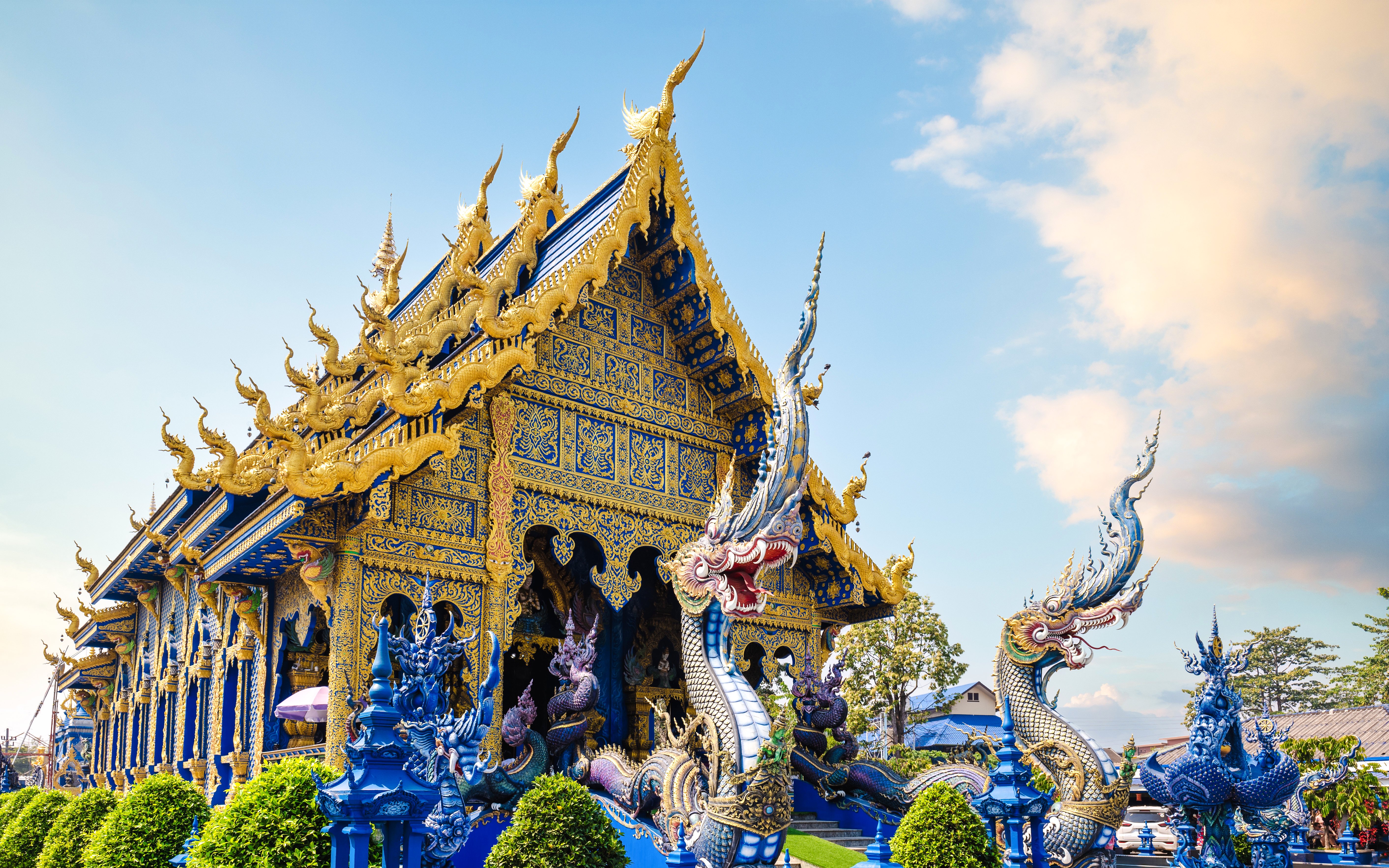 Wat Rong Suea Ten temple with intricate blue and gold architecture in Chiang Rai, Thailand.