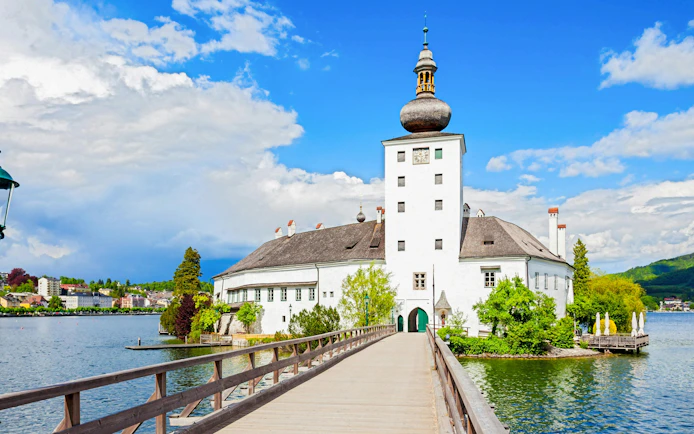 Schloss Ort castle with wooden bridge over lake in Hallstatt, Austria.