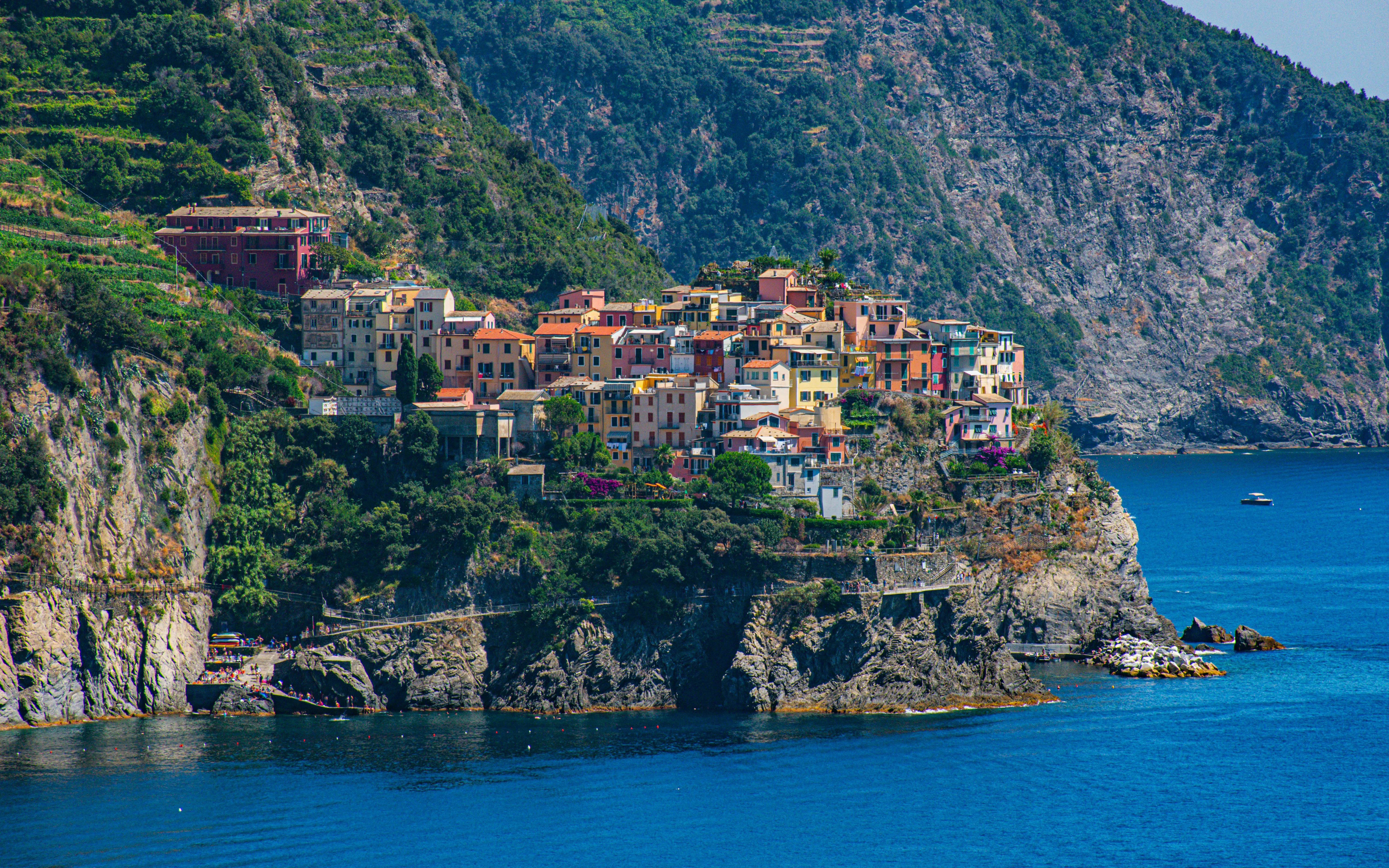 Colorful houses on a cliff in Corniglia, Cinque Terre, overlooking the sea.