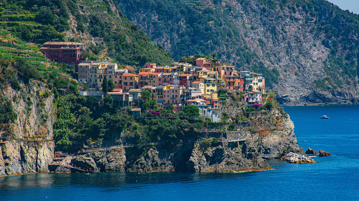 Colorful houses on a cliff in Corniglia, Cinque Terre, overlooking the sea.