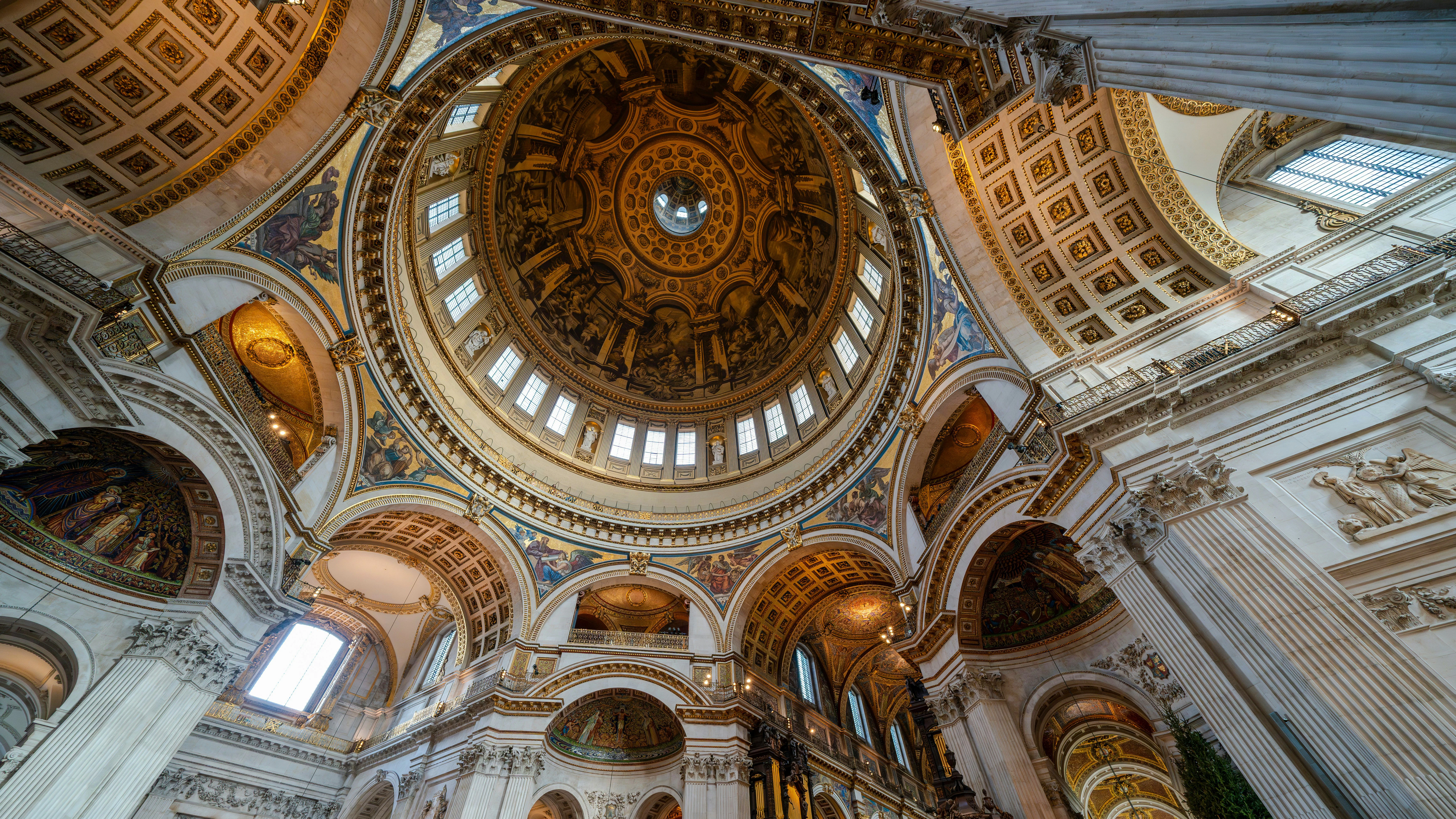 St Paul's Cathedral dome interior with ornate architecture and detailed frescoes.