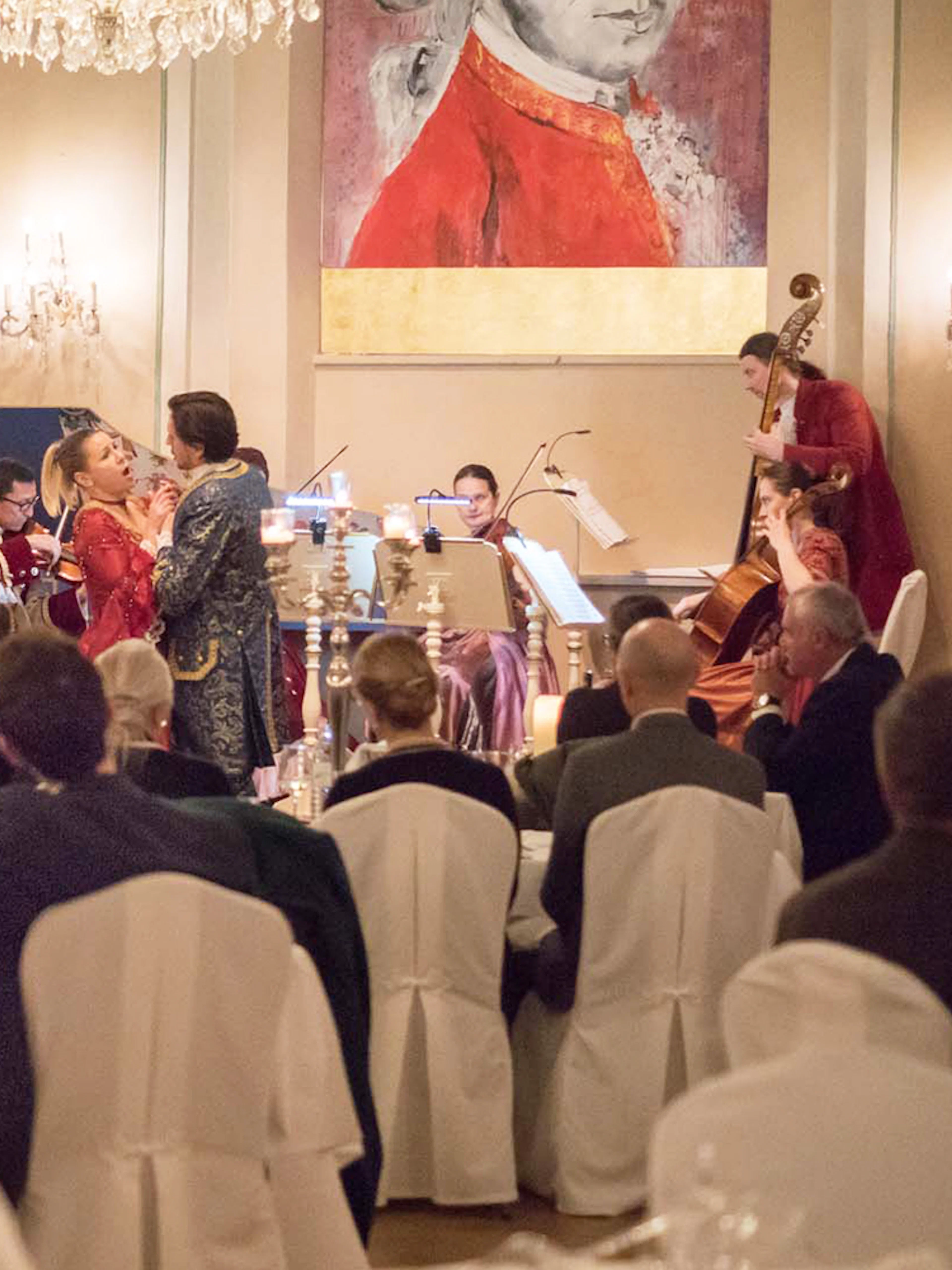 Mozart concert with performers in period costumes at a candlelit dinner in Salzburg.