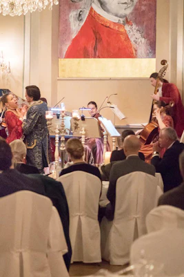 Mozart concert with performers in period costumes at a candlelit dinner in Salzburg.