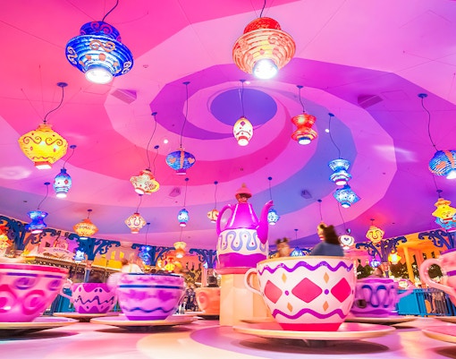 Colorful teacup ride at Tokyo Disneyland with vibrant hanging lanterns.
