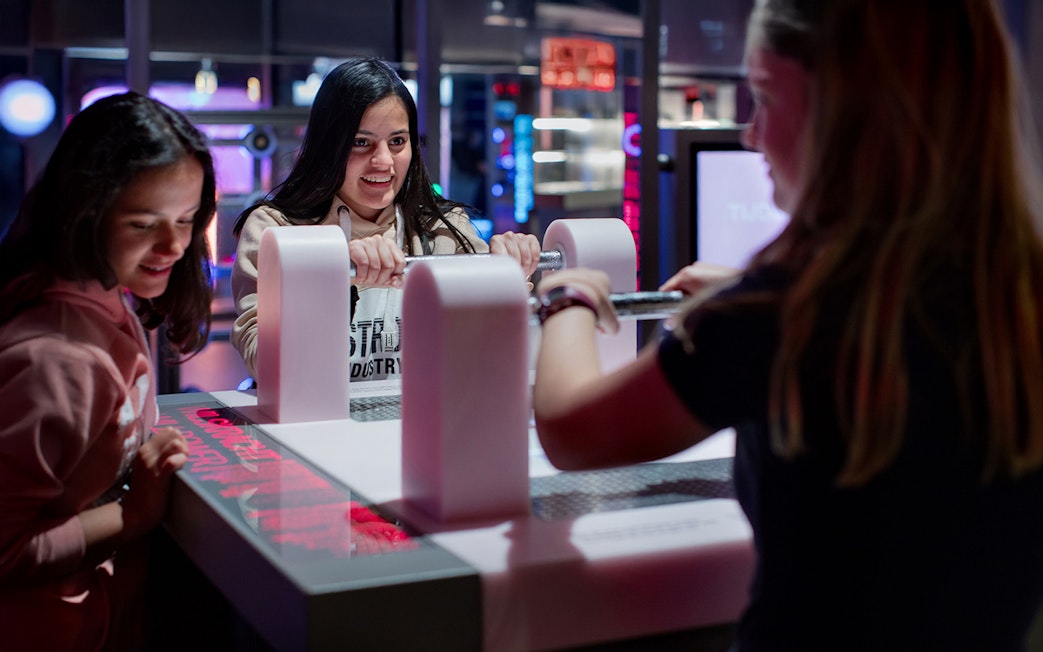 Visitors engaging with interactive exhibit at NEMO Science Museum, Amsterdam.