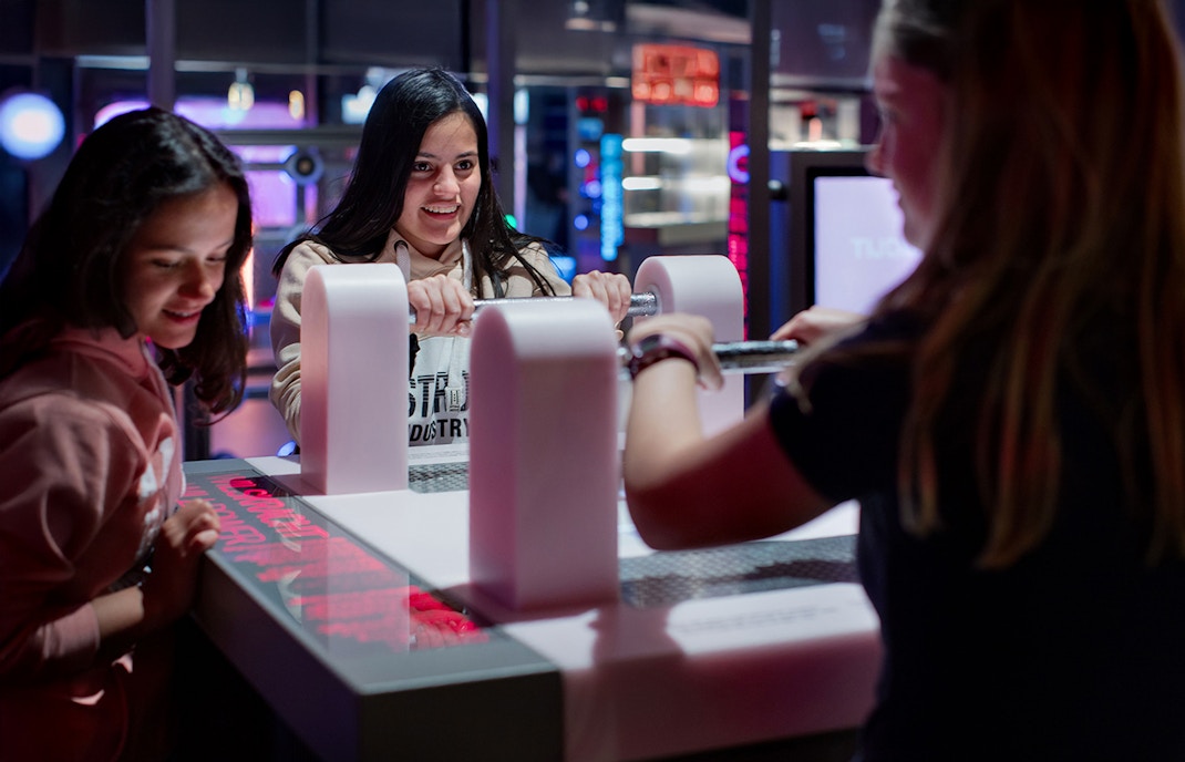 Visitors engaging with interactive exhibit at NEMO Science Museum, Amsterdam.