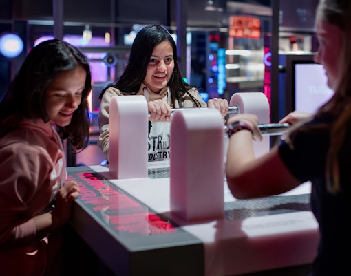 Visitors engaging with interactive exhibit at NEMO Science Museum, Amsterdam.