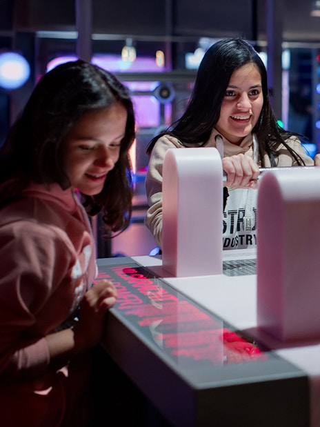 Visitors engaging with interactive exhibit at NEMO Science Museum, Amsterdam.