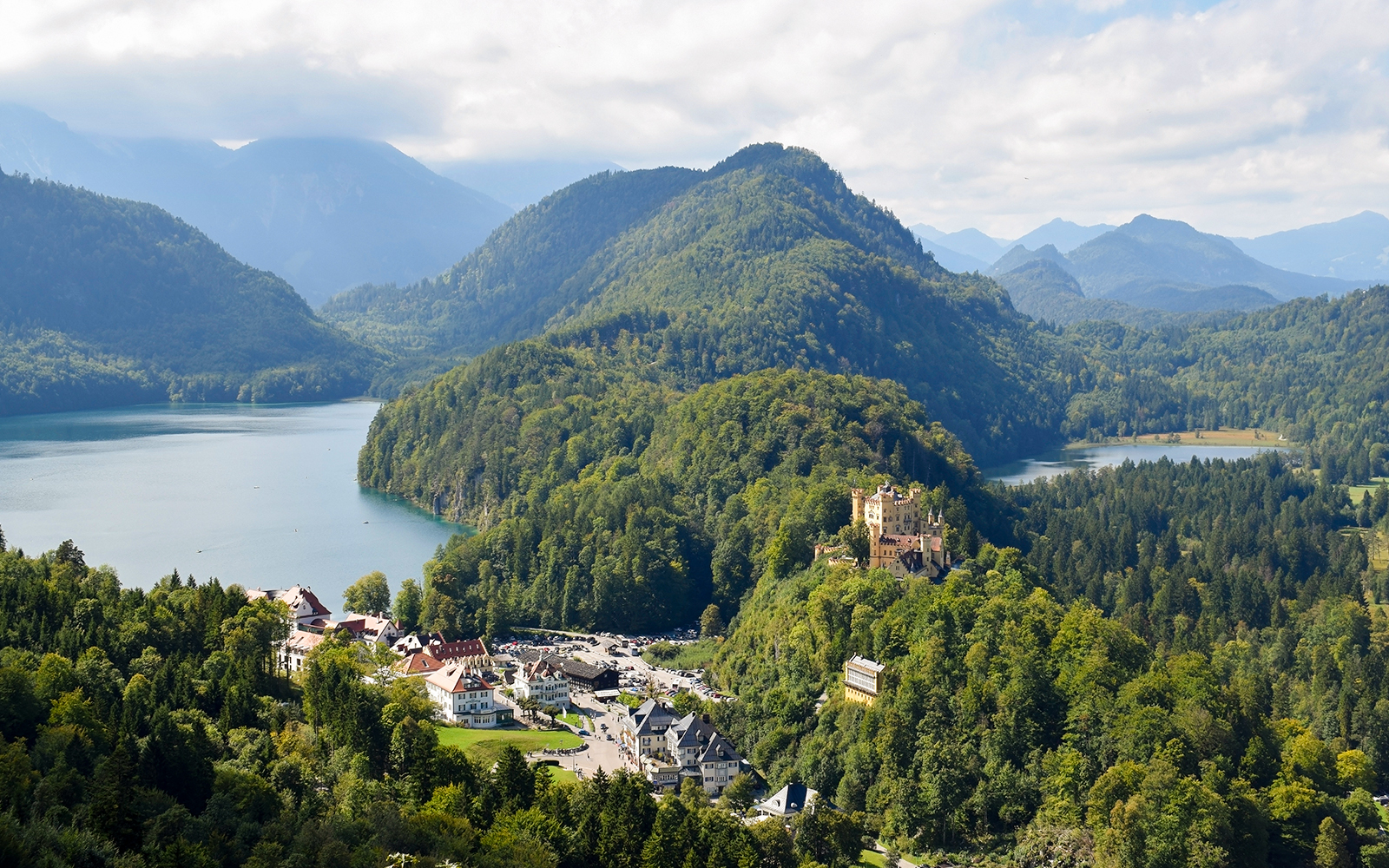 Panoramic view from Neuschwanstein Castle overlooking Bavarian mountains and lakes.