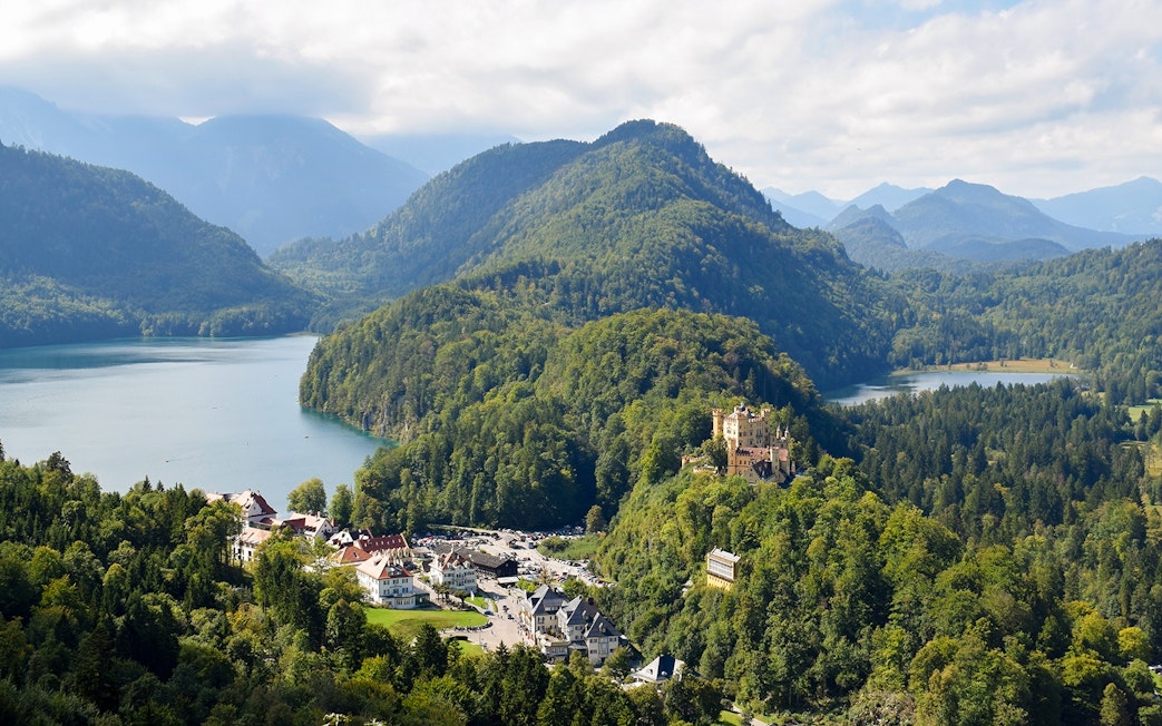 Panoramic view from Neuschwanstein Castle overlooking Bavarian mountains and lakes.