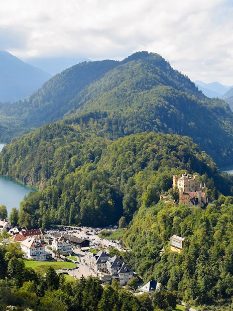 Panoramic view from Neuschwanstein Castle overlooking Bavarian mountains and lakes.