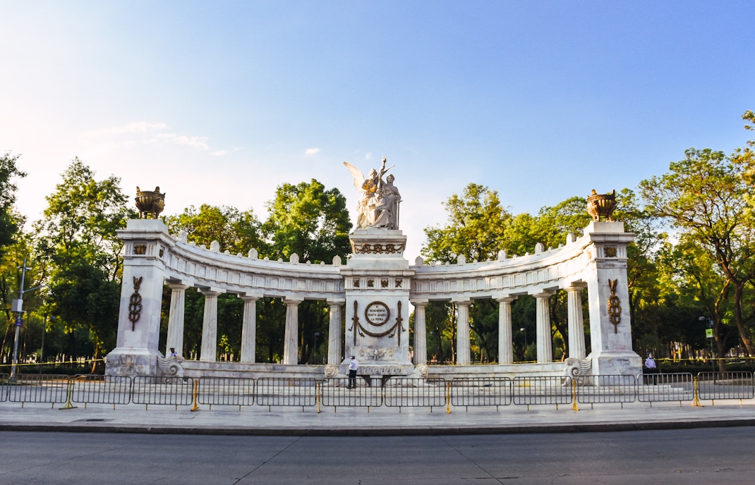 Juarez Hemicycle in Mexico City with tourists exploring the historic monument.
