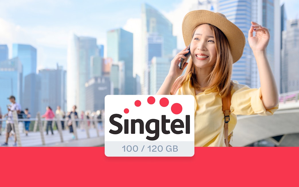 Tourist using Singtel prepaid SIM card in Singapore cityscape.