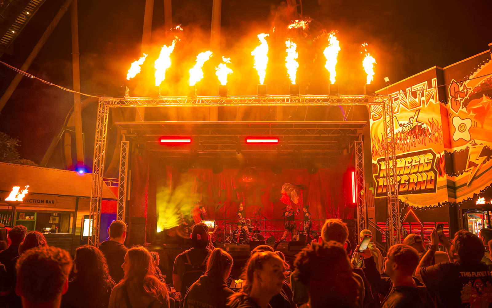 Stage with fire effects at Halloween event in Thorpe Park, crowd watching performance.