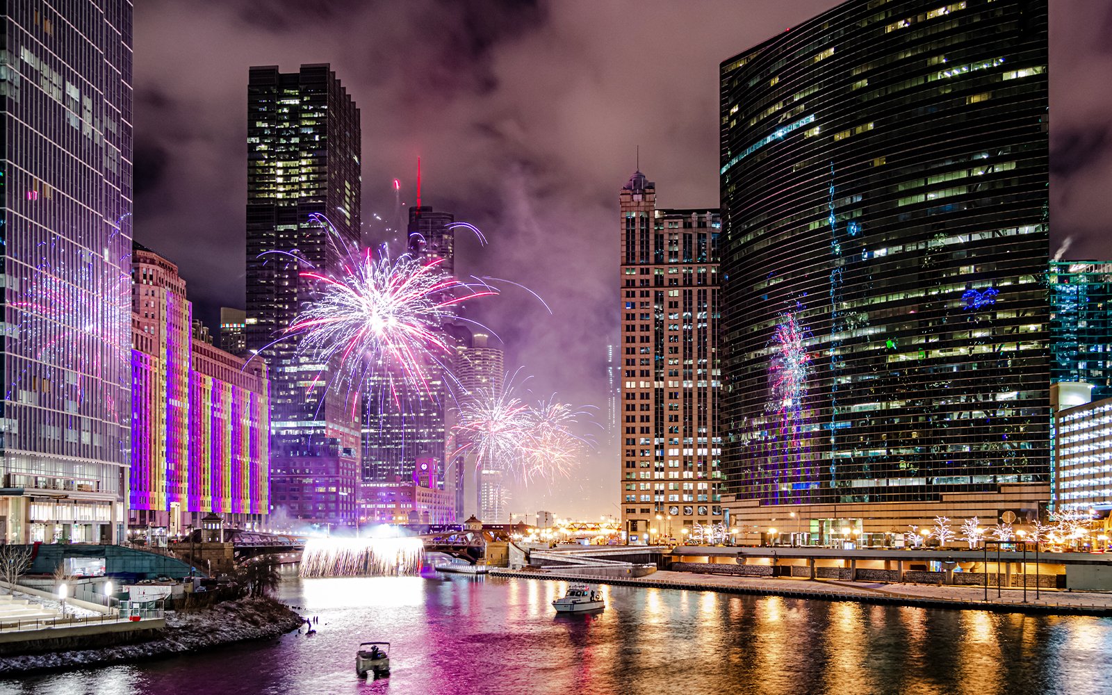 Fireworks over Chicago River with boats during dinner cruise.