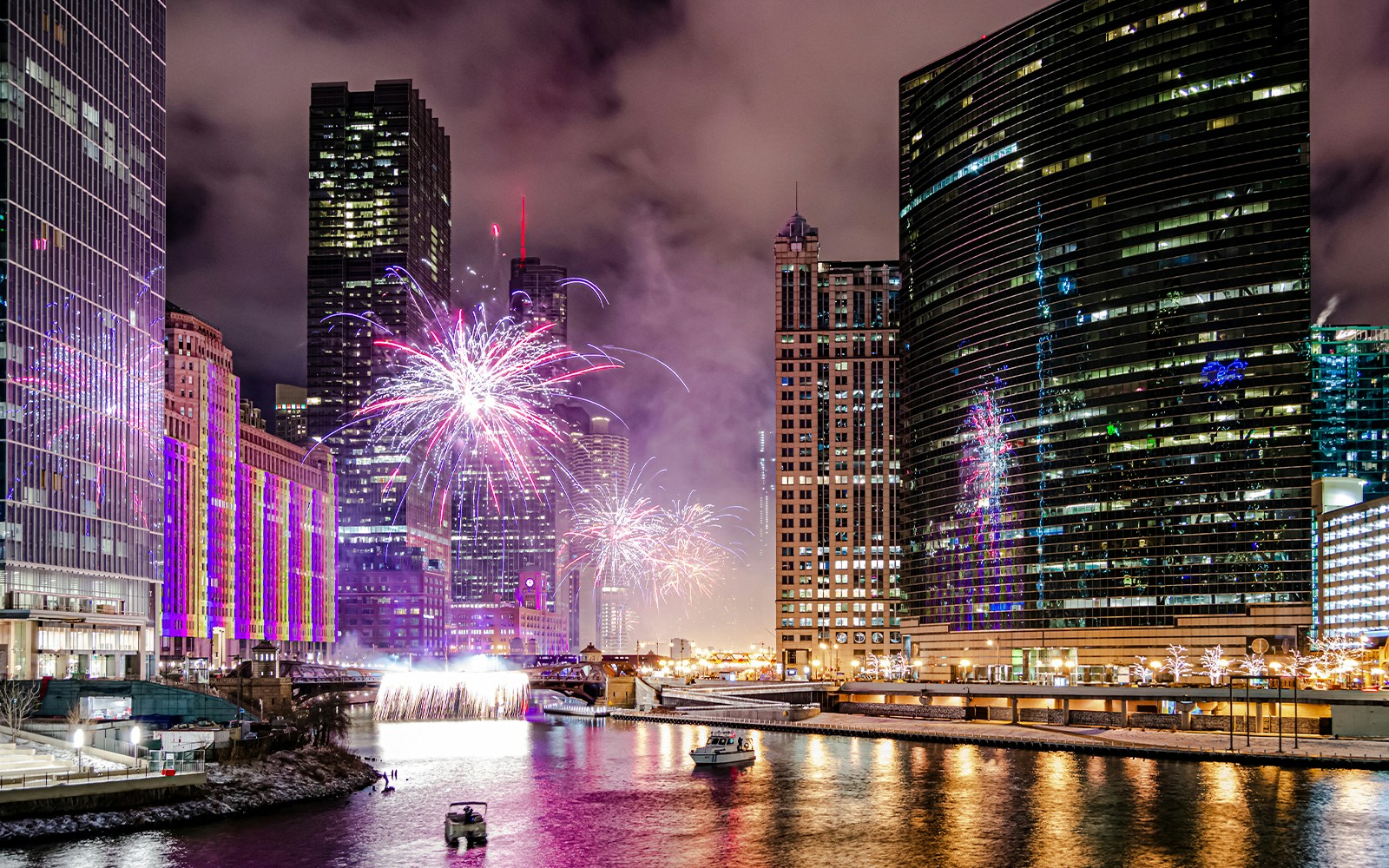 Fireworks over Chicago River with boats during dinner cruise.