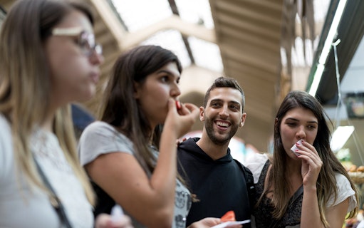 Group enjoying snacks during guided urban trek in Naples.