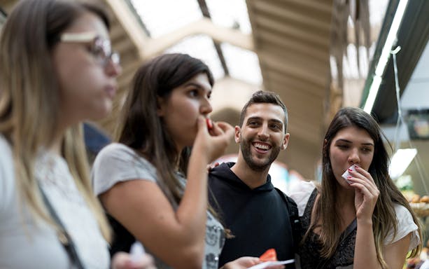Group enjoying snacks during guided urban trek in Naples.