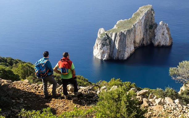 Trekking path along coastal cliffs from Masua to Cala Domestica, Sardinia.