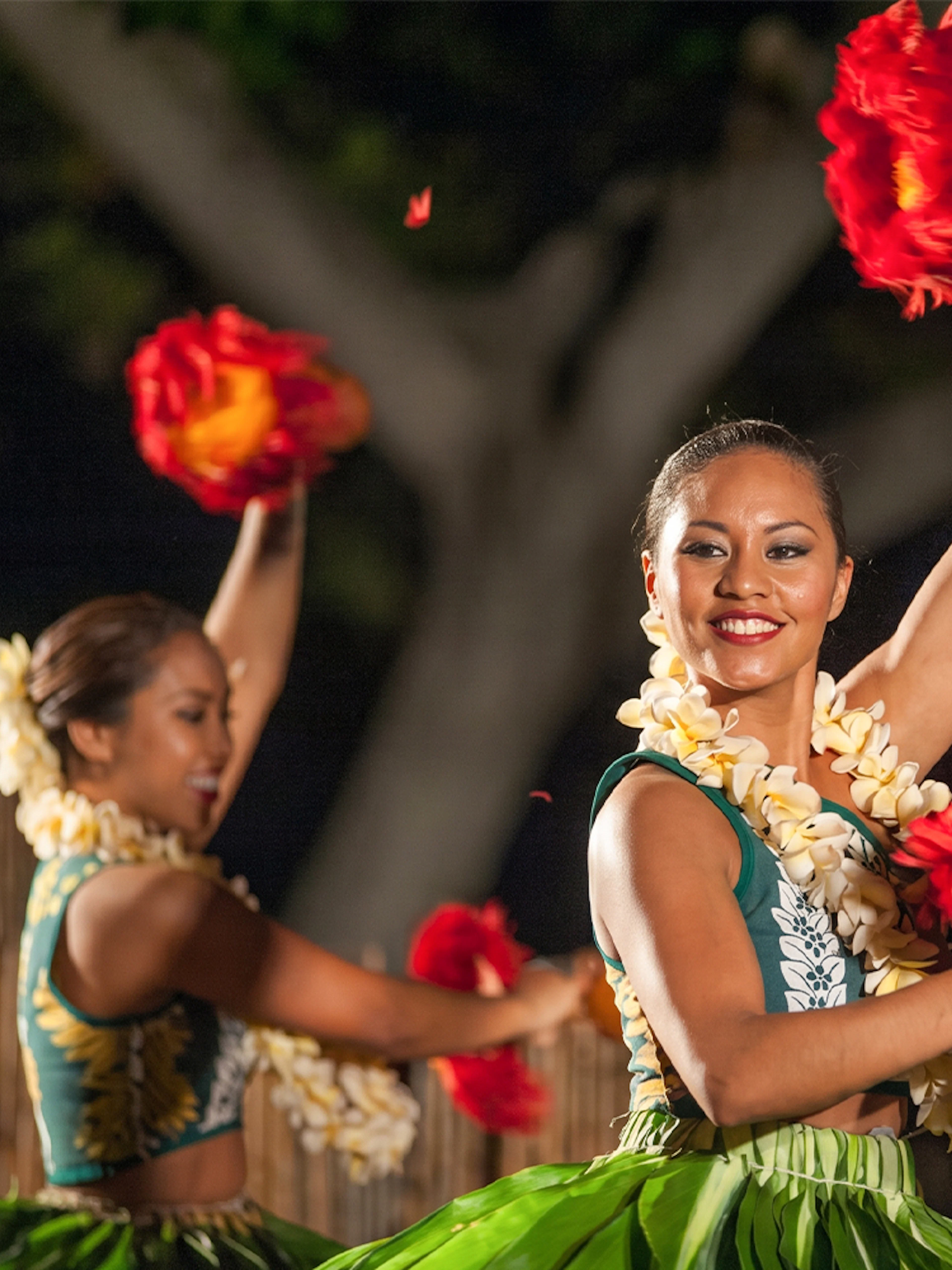 Dancers performing traditional hula at Voyagers of the Pacific Luau in Hawaii.