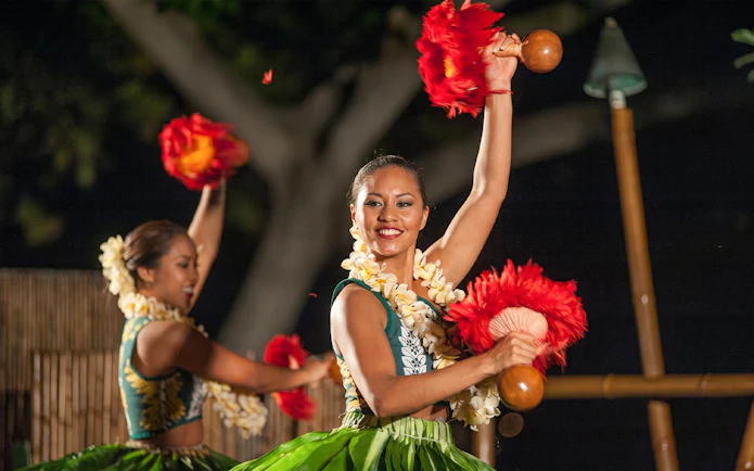 Dancers performing traditional hula at Voyagers of the Pacific Luau in Hawaii.