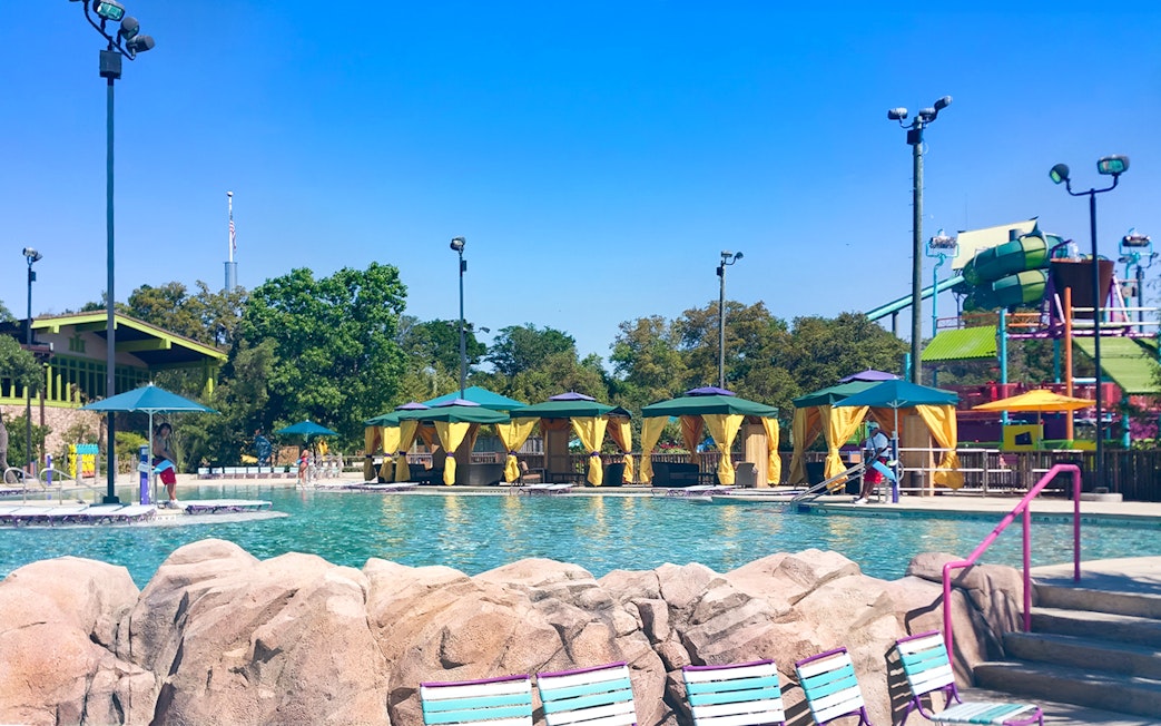 Guests enjoying poolside cabanas at Aquatica San Antonio, Texas.